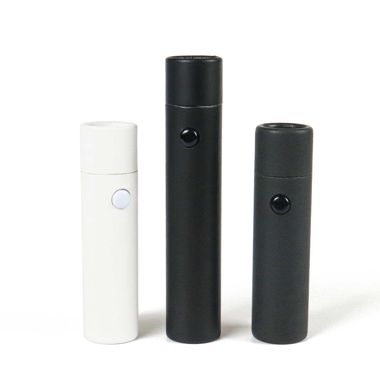 Three cylindrical vape cartridges in white and black finishes, featuring button controls and sealed caps, displayed against a clean white background.