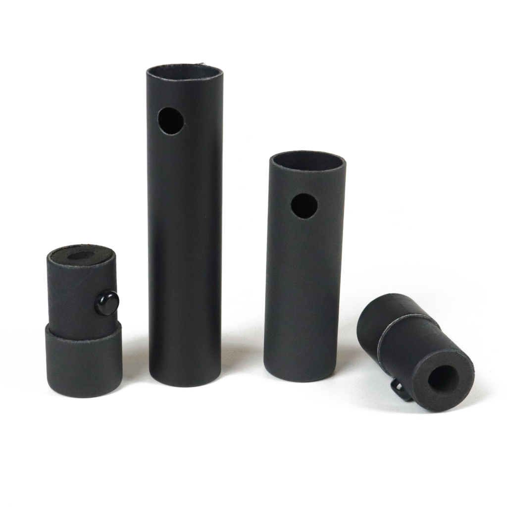 Four black cylindrical protective sleeves of varying sizes, designed to securely hold vape cartridges, featuring side ventilation holes and precision-fit ends.