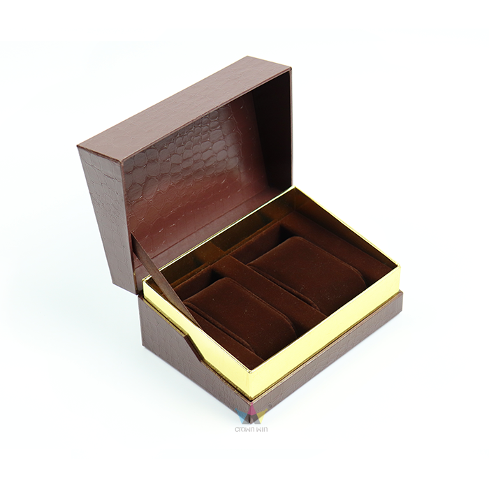 Brown textured rigid watch box with gold edges and velvet-lined compartments—designed for storing multiple luxury timepieces with maximum protection.
