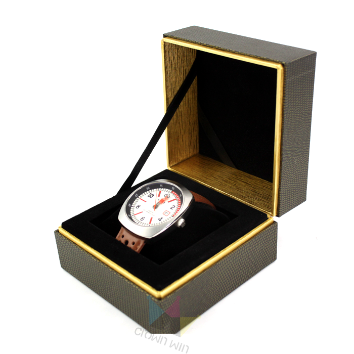 Brown textured watch box with gold trim and black velvet lining, housing a silver-tone watch with brown leather strap—designed for maximum protection during shipping and storage.