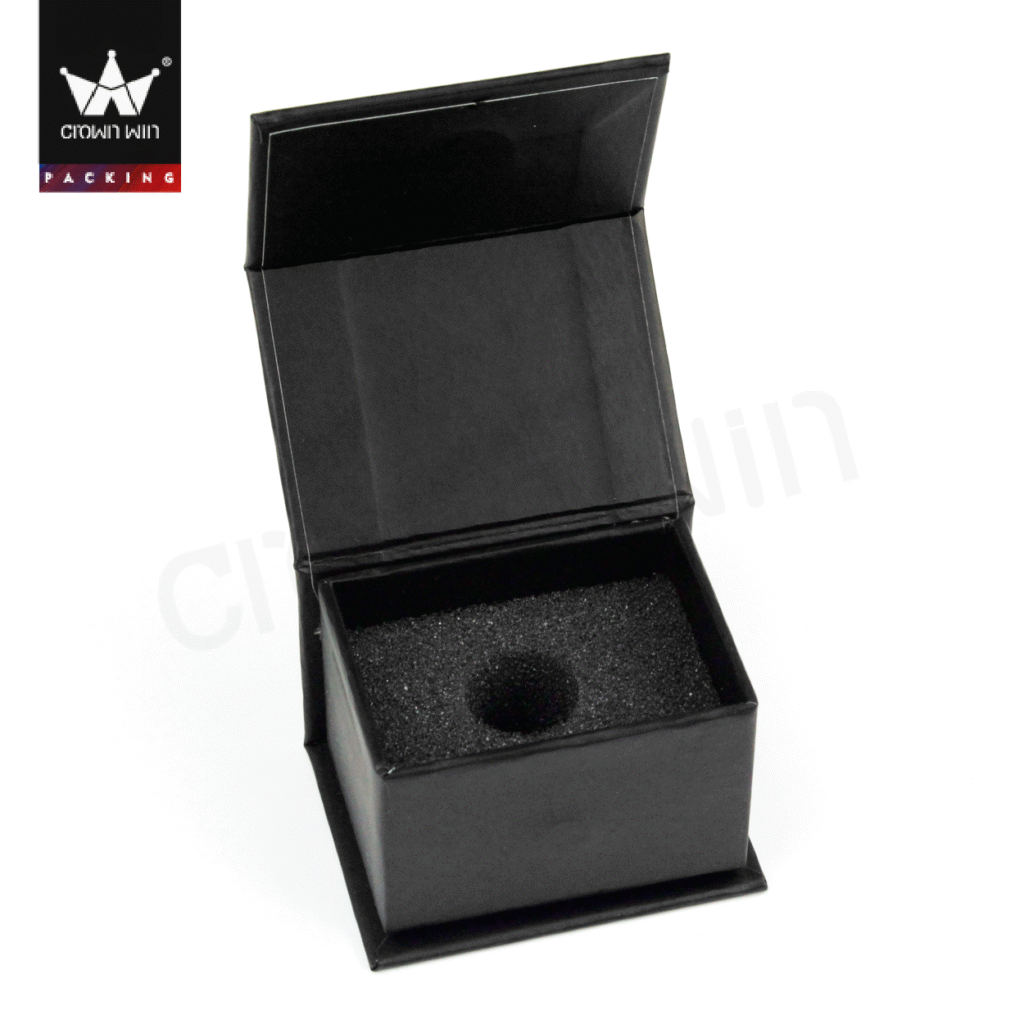 Open black rigid box with custom-cut EVA foam insert featuring a circular cavity for secure product placement.