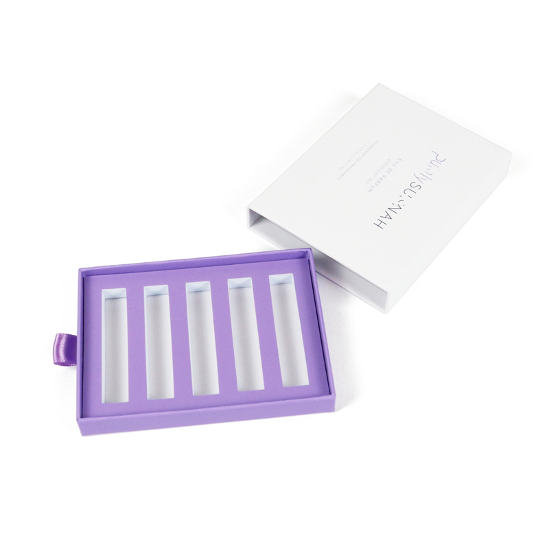 Purple drawer-style tray with five vertical slots for vape cartridges, paired with a white outer box, demonstrating organized access and internal retention.Purple drawer-style tray with five vertical slots for vape cartridges, paired with a white outer box, demonstrating organized access and internal retention.