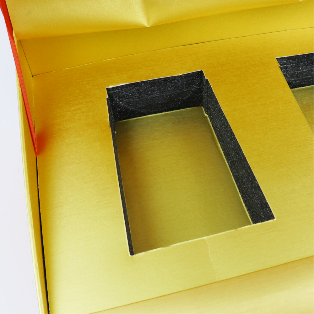Black EVA foam insert precisely fitted into a yellow box cavity, designed to immobilize vape cartridges and absorb impact during transit.
