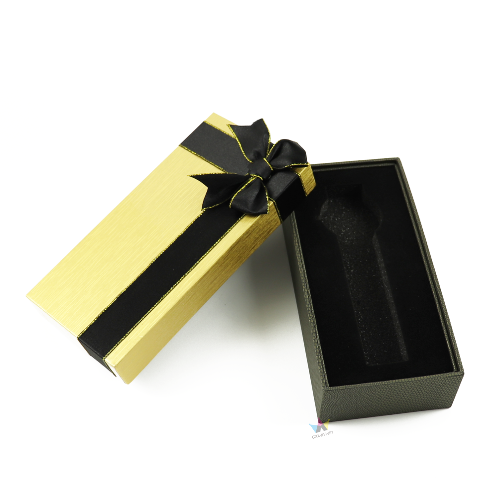 Gold long rectangular watch box with black satin ribbon and custom-cut velvet insert—designed for premium protection during shipping and storage.