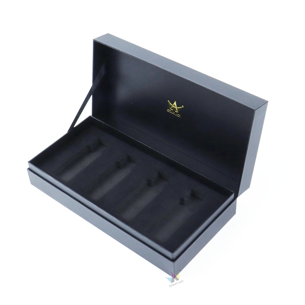 Black matte-finish rigid box with gold embossed logo and custom-molded interior tray, showcasing structural integrity and secure product containment.