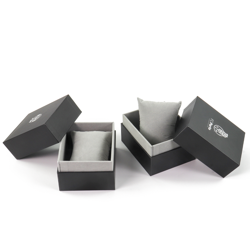 Black rigid watch box with gray velvet pillow insert and minimalist branding—designed for understated elegance and premium brand positioning.