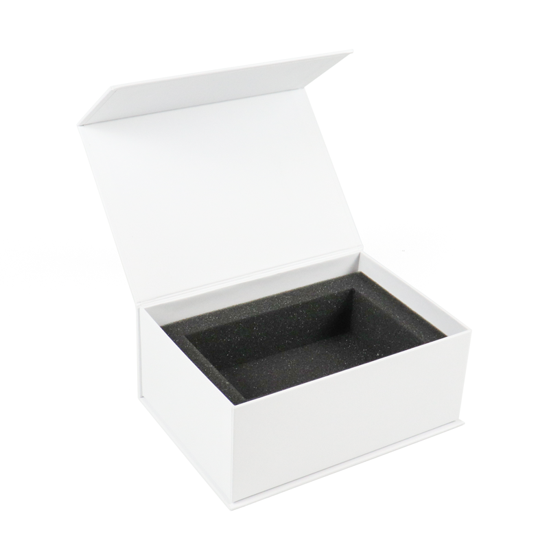 White rigid box with open lid revealing custom black foam insert, designed to securely hold vape cartridges and prevent movement that could compromise child resistance.