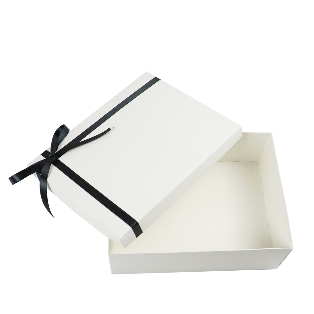 Open white rigid box with black satin ribbon tied in a bow on the lid, showcasing clean lines and minimalist design.