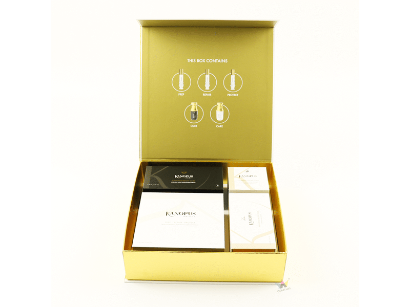 Custom gold hinged-lid rigid cosmetic gift box with printed interior instructions and fitted compartments for skincare, haircare and luxury beauty product packaging.