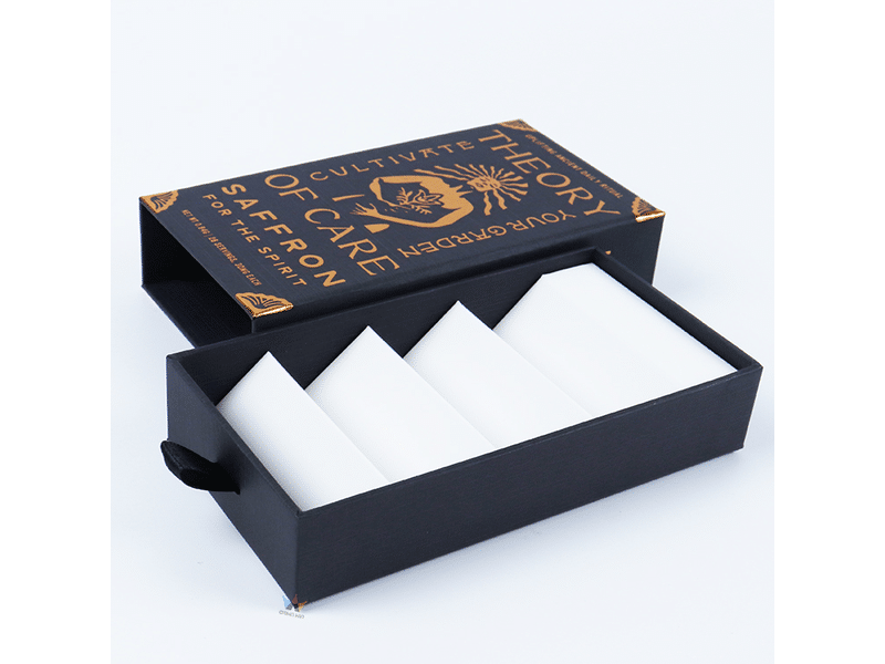 Custom black slide-out drawer rigid box with copper foil printing, ribbon pull tab and white divider insert for premium cards, accessories and gift packaging.