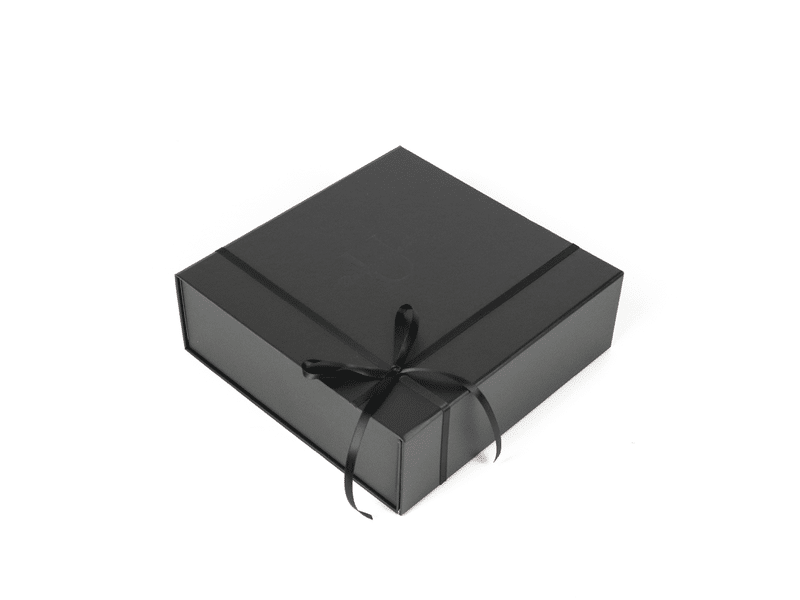Custom black foldable magnetic rigid gift box with satin ribbon bow closure, suitable for luxury cosmetics, apparel and premium retail packaging.
