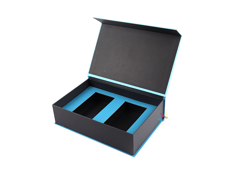 Custom black magnetic closure rigid gift box with a blue precision-cut foam insert and two product compartments for cosmetics, electronics and premium retail packaging.