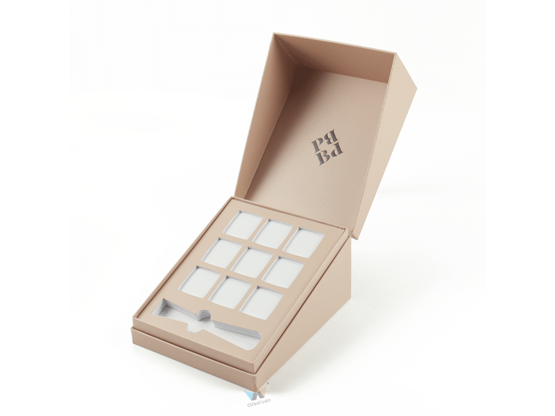Custom beige hinged rigid cosmetic gift box with nine product compartments and a precision die-cut insert, designed for skincare samples, ampoules and luxury beauty packaging.