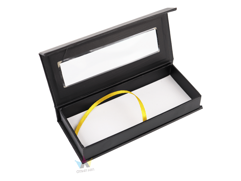 Custom black hinged rigid gift box with a transparent window lid, white protective insert and yellow ribbon pull for jewelry, cosmetics and premium product packaging.