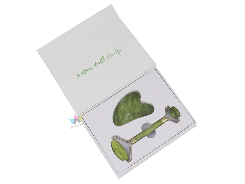 Custom white hinged rigid gift box with fitted insert for green jade gua sha stone and facial roller, designed for skincare tools and luxury beauty packaging.