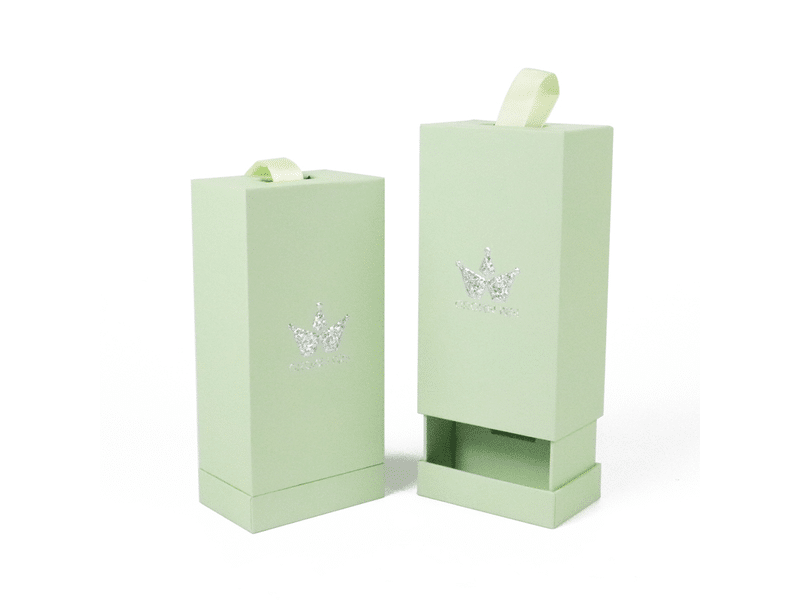 Custom mint green vertical drawer rigid gift boxes with ribbon pull tabs and silver foil crown logos, suitable for cosmetics, perfume and luxury retail packaging.