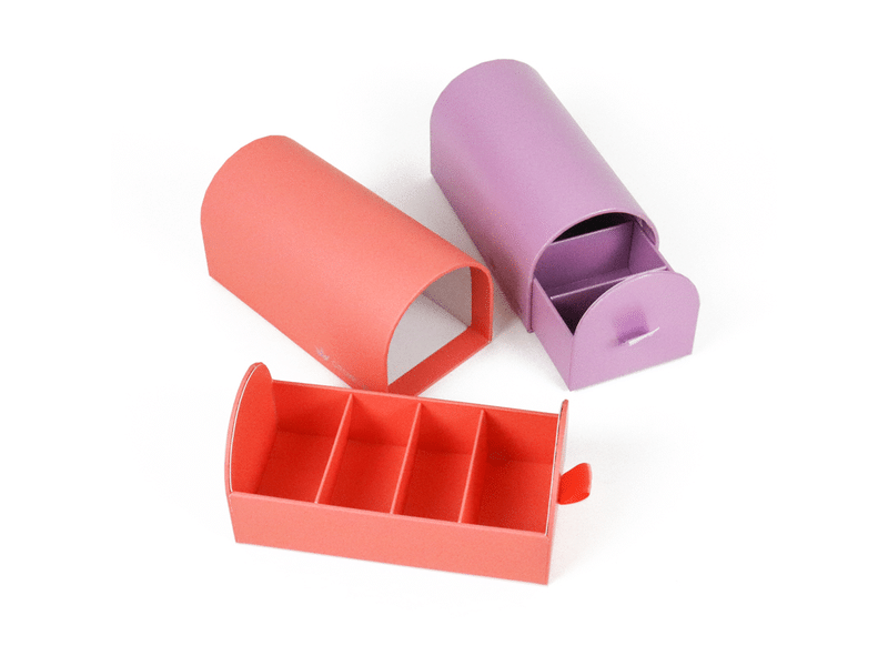 Custom coral and purple arched drawer rigid gift boxes with ribbon pull tabs and divided inner trays for cosmetics, jewelry, candy and premium gift packaging.
