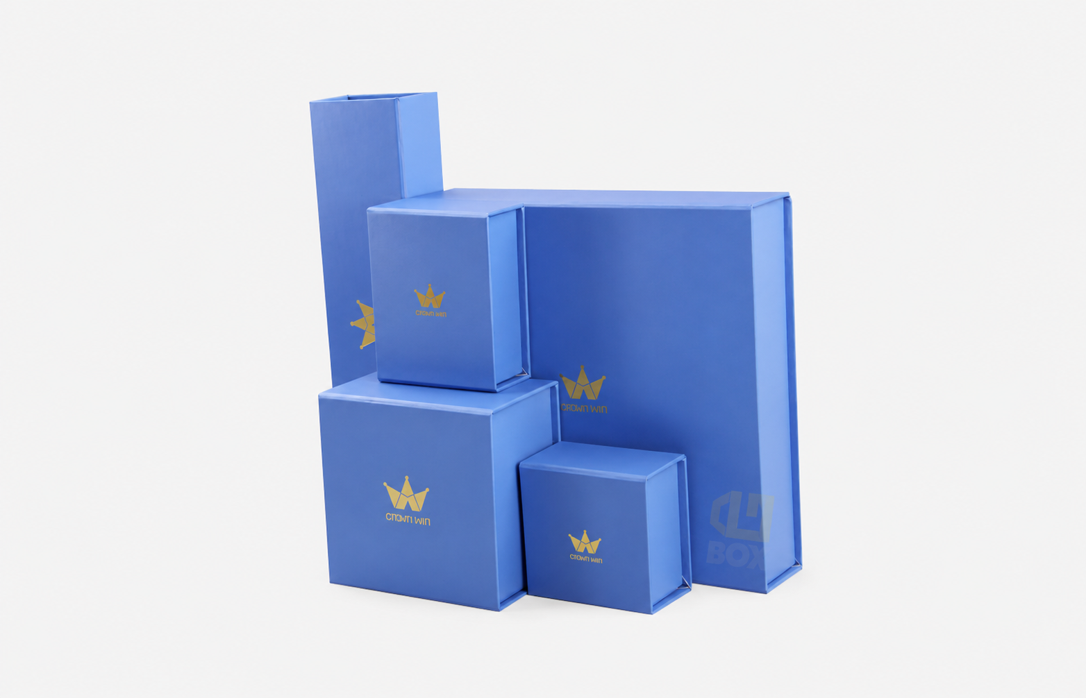 Custom blue rigid gift packaging boxes in multiple sizes with gold foil logos for premium cosmetics, jewelry and luxury products.