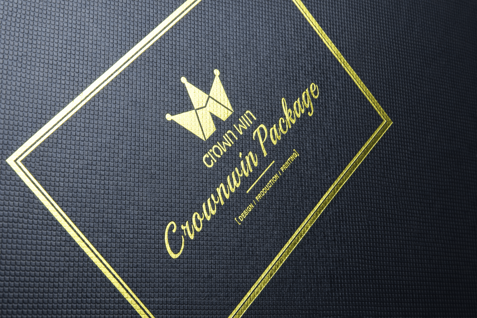 Close-up of a custom black textured rigid packaging box with gold foil stamping, decorative borders and premium logo branding.