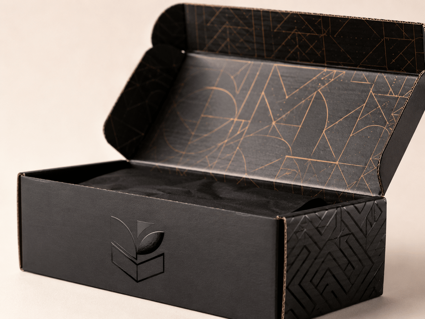 Open custom black corrugated mailer box with metallic geometric interior printing and premium branded finish for luxury product packaging