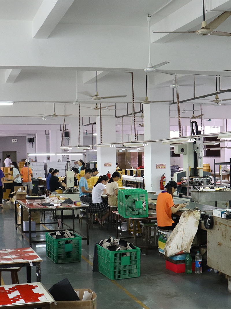 Workers producing and assembling custom cardboard packaging boxes in a professional paper box manufacturing workshop