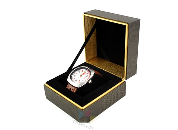 Luxury black and gold rigid watch gift box with velvet interior insert, showcasing premium wristwatch packaging for high-end brand presentation.