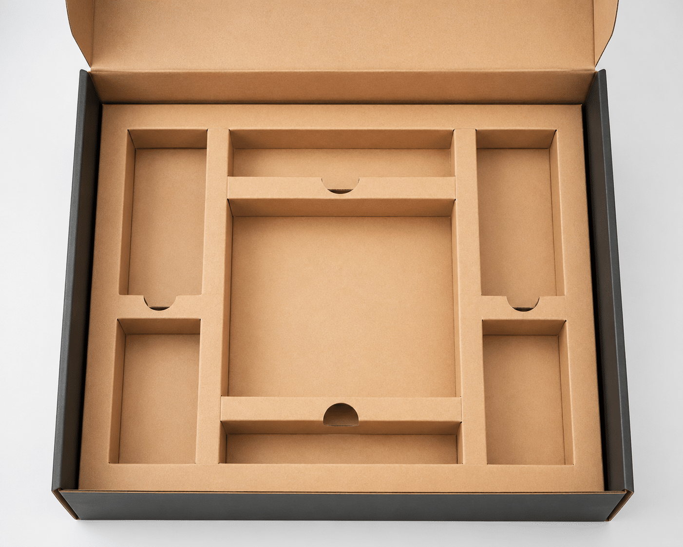Custom kraft paperboard insert with multiple compartments for organizing and protecting products inside a gift box.