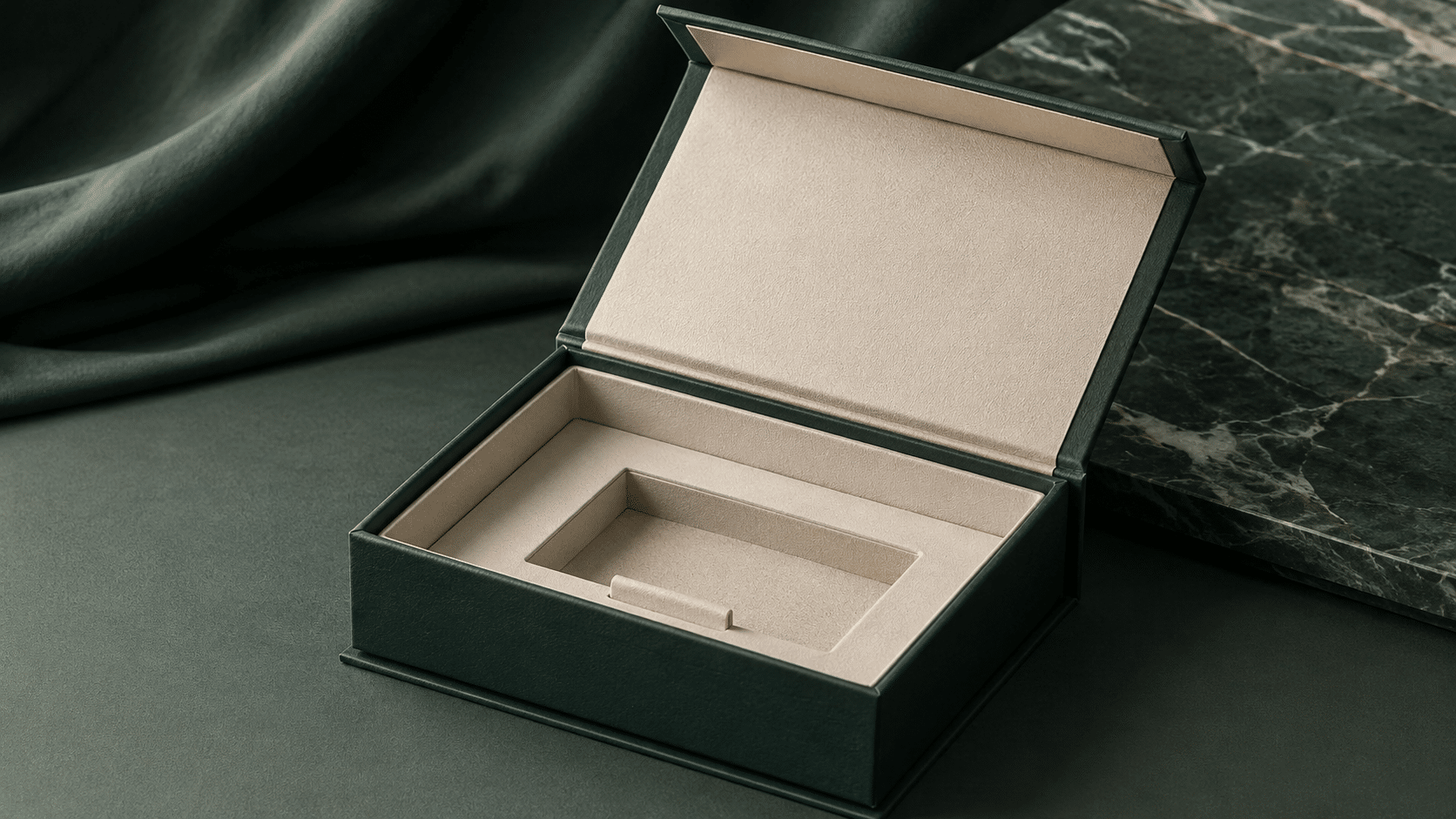 Open dark green magnetic closure rigid box with a cream custom insert for luxury product presentation and protection.