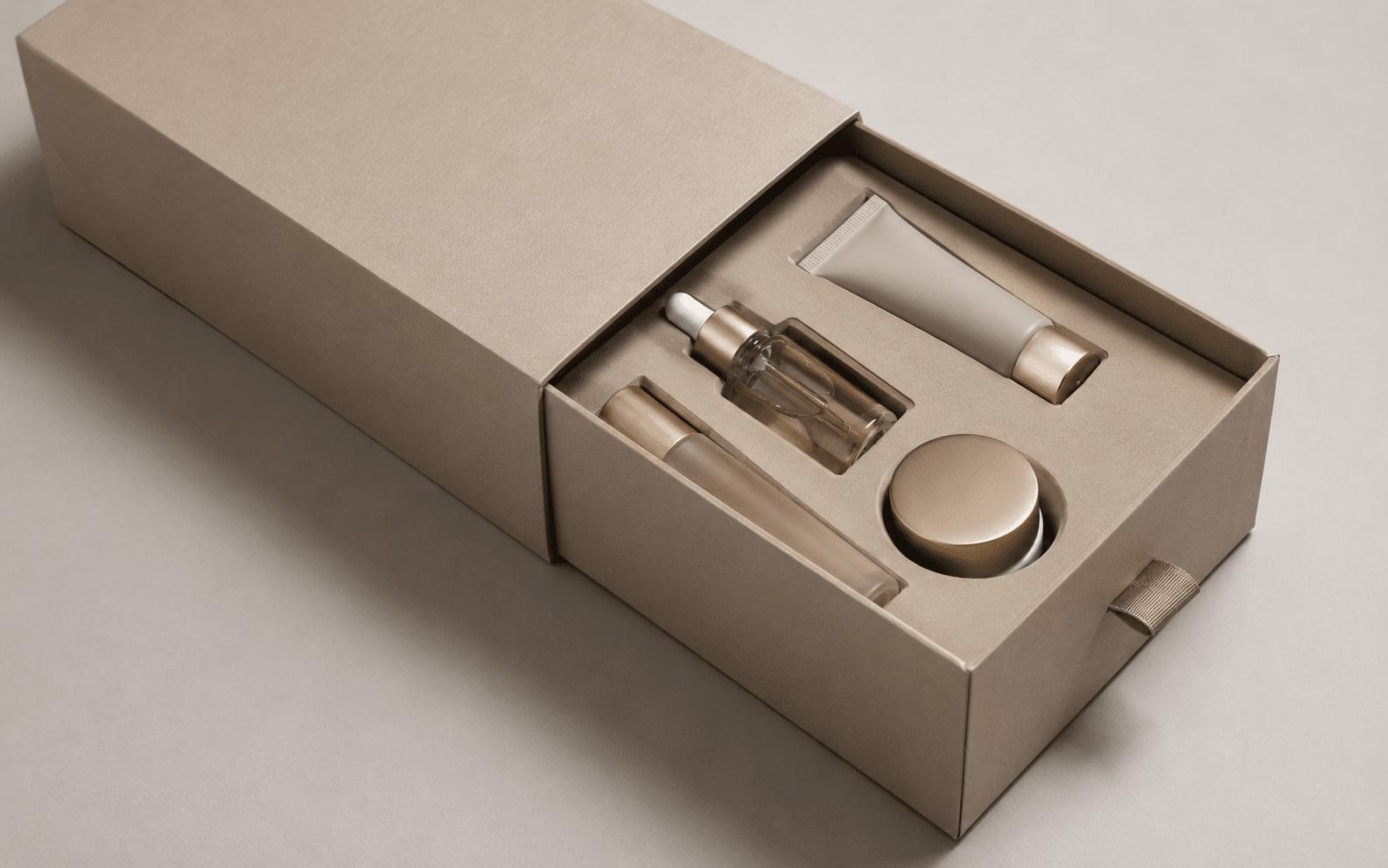 Beige luxury drawer box with a custom protective insert holding skincare bottles, a cream jar, dropper serum and cosmetic tube.