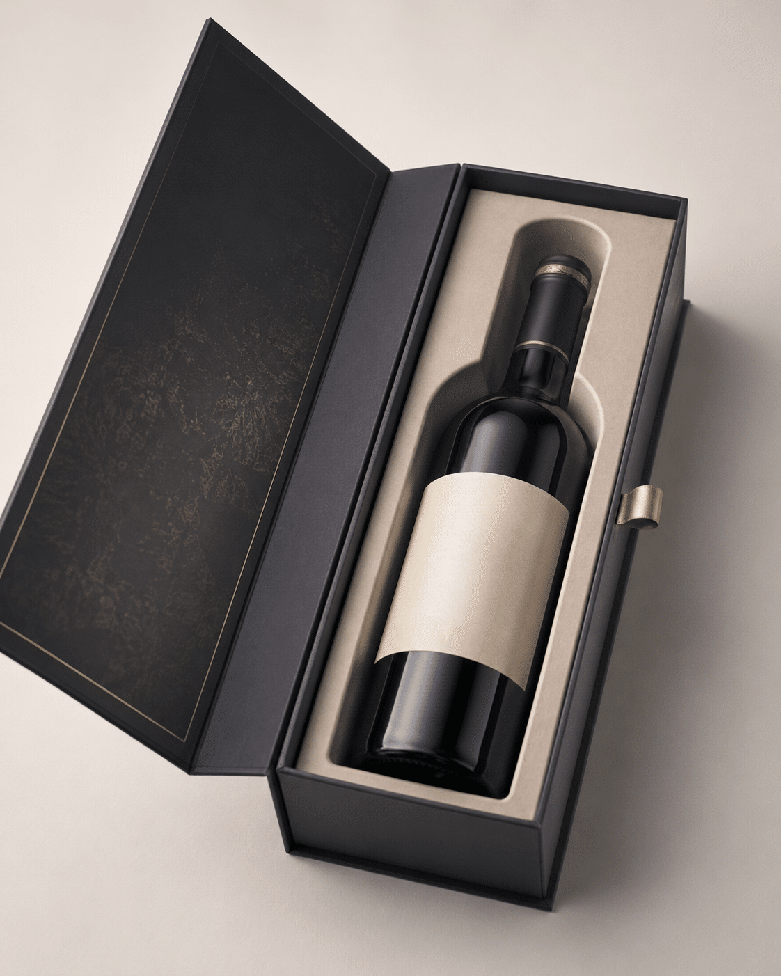 Open black hinged rigid wine box with beige fitted insert, gold detailing and ribbon pull tab for premium presentation
