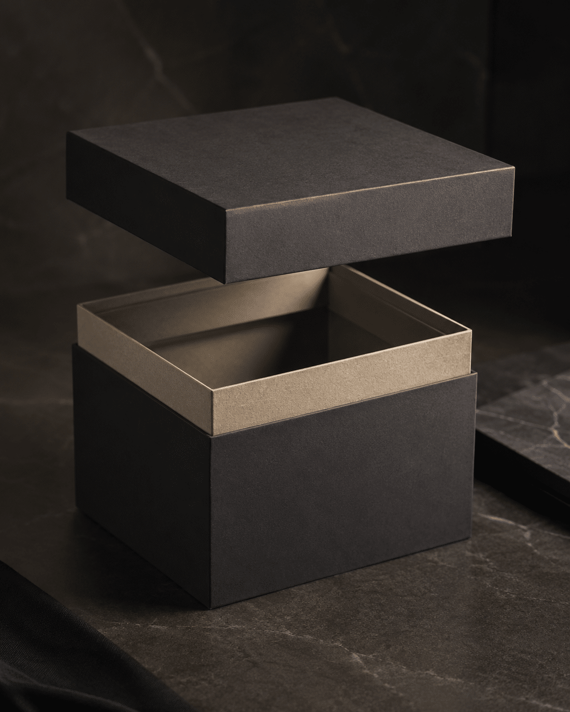 Premium two-piece shoulder neck rigid box with contrasting gold inner tray and black outer paper