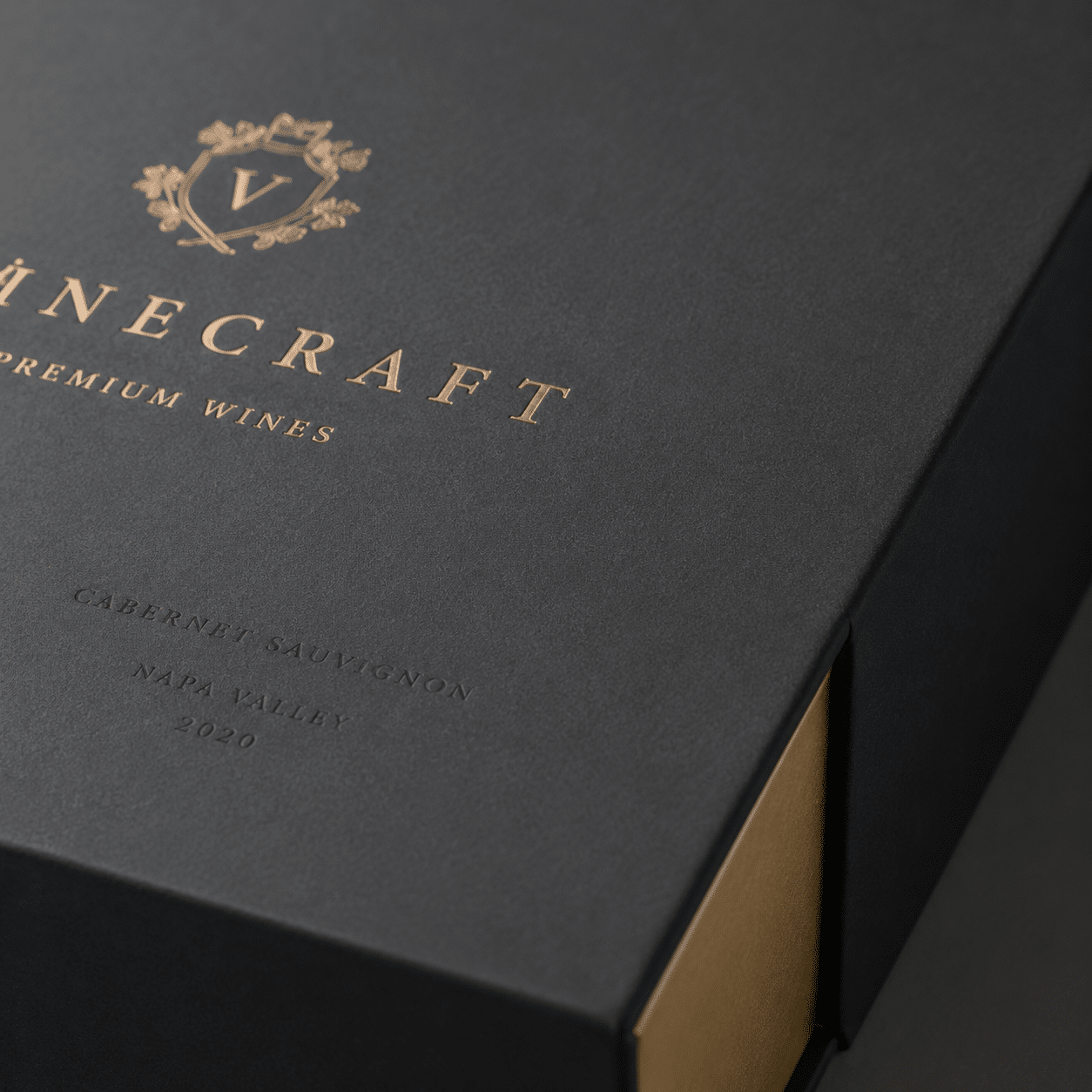 Premium black rigid wine gift box featuring gold foil logo printing, subtle debossed text and a gold-colored inner tray