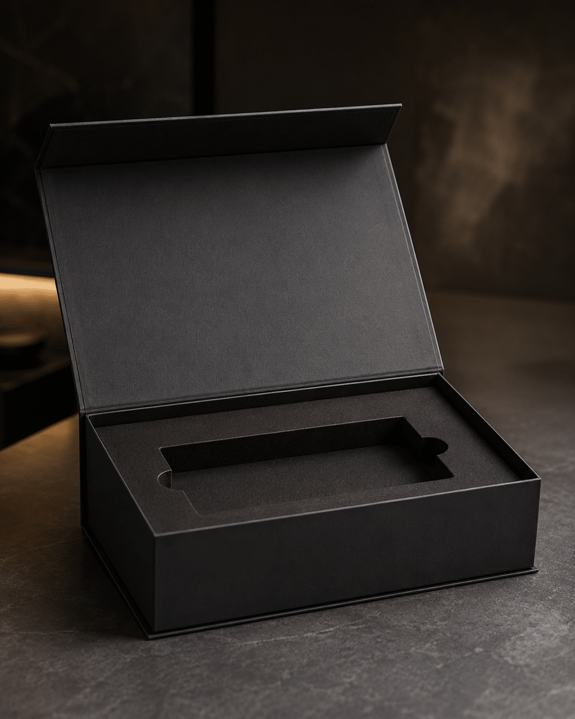 Open black magnetic closure rigid box with a precision-cut foam insert for secure product packaging