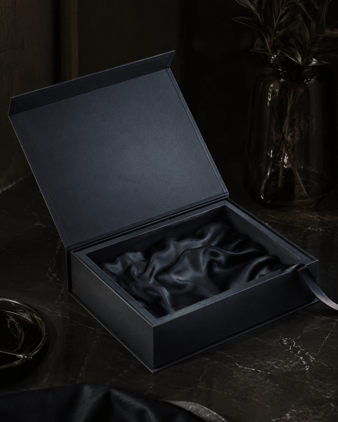 Open navy rigid gift box with soft satin fabric insert for jewelry and luxury product packaging