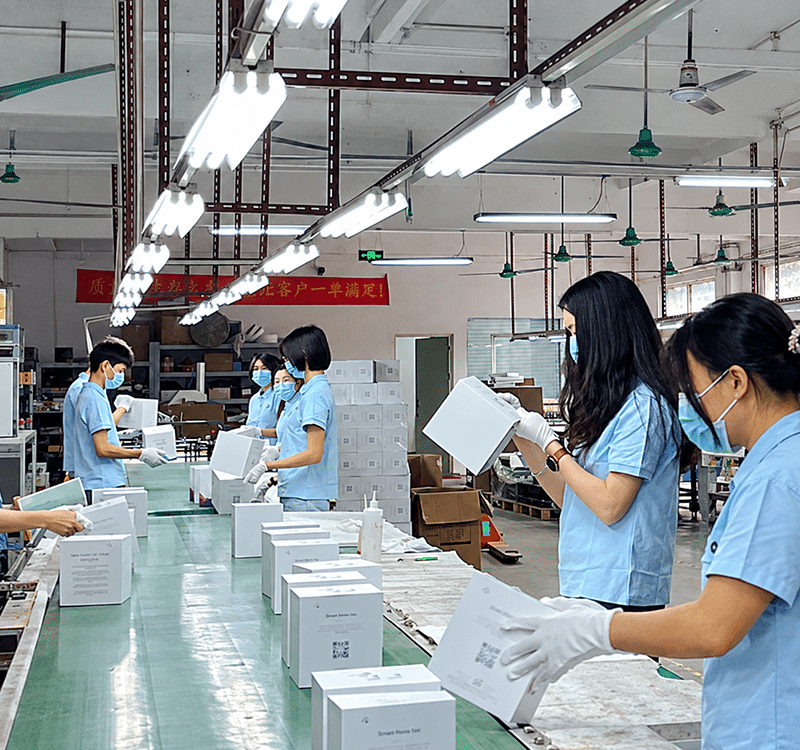 Crown Win production staff assembling and organizing custom packaging boxes on the factory line