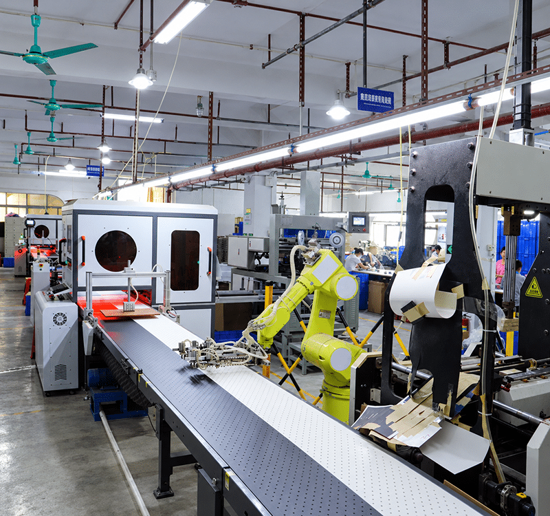 Packaging production equipment and operators inside the Crown Win manufacturing facility